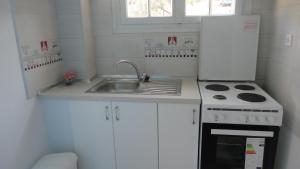 a small kitchen with a sink and a stove at Casa di Giorgio in Nikiana