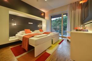 Postel nebo postele na pokoji v ubytování Omnia Hotel Relax & Wellness