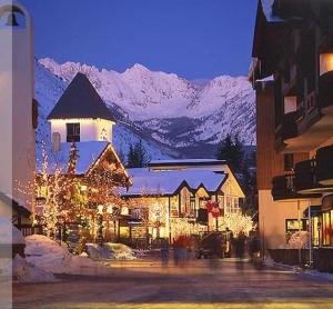 a building with christmas lights in front of a mountain at Strawberry Park Splendid Slopes View in Beaver Creek