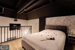 a bedroom with a bed with red hearts on it at Le Loft Spa au coeur de Metz (unenuitametz) in Metz
