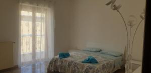 Postel nebo postele na pokoji v ubytování Grimaldi Guest Apartment