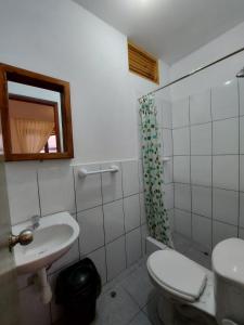 a bathroom with a toilet and a sink and a shower at El Capricho Paracas in Paracas