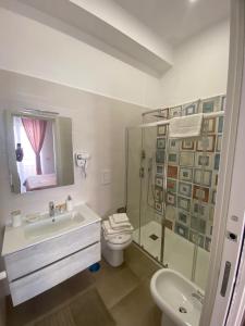 a bathroom with a sink and a toilet and a shower at B&B 80056 Ercolano in Ercolano