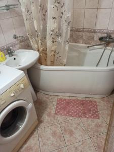 a bathroom with a sink and a toilet and a bath tub at 3-х комнатная квартира in Okhtyrka