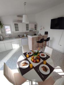 a table with plates of food on it in a kitchen at Apartment Sky Central in Makarska