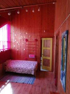a bedroom with a bed and a yellow door at Tuuli Majutus in Tõrva