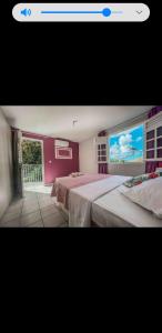 two beds in a room with a window at VILLAS AUMIS 2MR in Fort-de-France