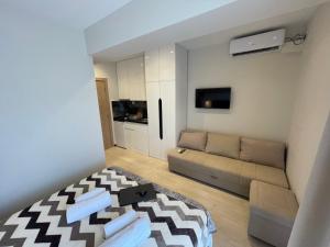 a small living room with a couch and a tv at Grand Agia Triada in Agia Triada