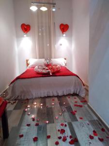 a bedroom with a bed with red hearts on the floor at Excellency apartmani in Banja Luka