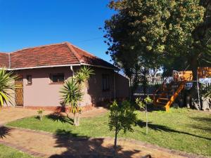 a small house with a staircase in the yard at Coons Cove in Cape Town