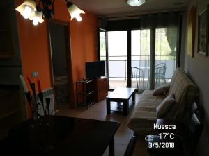 a living room with a couch and a table at Apartamento rural Escarla 1-3 in Aren