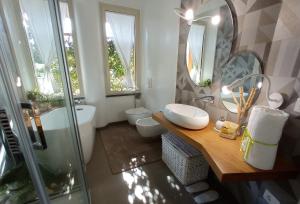 a bathroom with a sink and a toilet and a mirror at B&B Casa Althea in Milo +15 photos