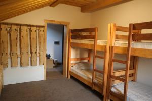 a room with two bunk beds and a doorway at Пасторальний дім імені Владики Мілана in Bohdan