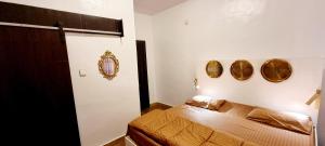 a bedroom with a bed and two mirrors on the wall at Epic Prime Apartments in Ikeja
