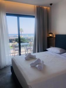 a hotel room with a bed with towels on it at Aquarius Beach Hotel in Faliraki