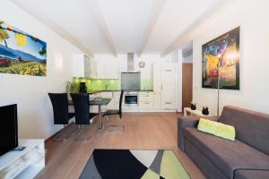a living room with a couch and a table at Villa Floris in Bressanone