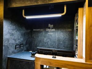 a hair salon with a mirror on the wall at Hotel City Code in Zenica