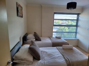 Een bed of bedden in een kamer bij Vetrelax Colchester Apartment