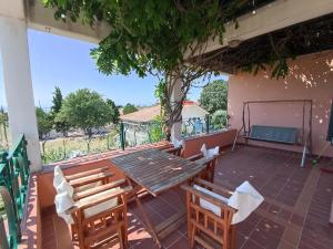 a table and chairs on the patio of a house at Olgas Villa in Aroyí