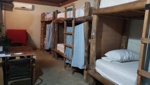 a room with four bunk beds and a desk at Las Porrocas Backpacer's in Pedasí Town