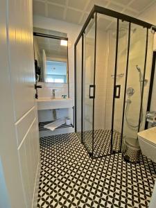 a bathroom with a shower and a sink at Vahide Dalyan in Çeşme +20 photos