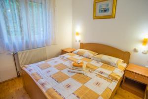 a bedroom with a bed with a quilt on it at Knežević Apartment in Žabljak