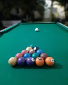 a group of billiard balls on a green pool table at PousadaRecanto684Guarujá in Guarujá