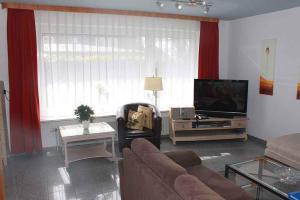 a living room with a couch and a tv at Apartments in Westerland/Sylt 38535 in Westerland