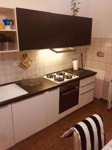 a kitchen with a black and white stove top oven at Casa relax in Collegno