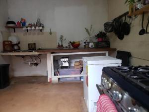 a kitchen with a stove and a counter top at Las Porrocas Backpacer's in Pedasí Town