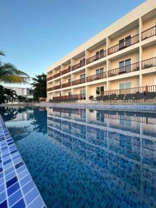 a large swimming pool in front of a hotel at Samsara Cliff Resort in Negril