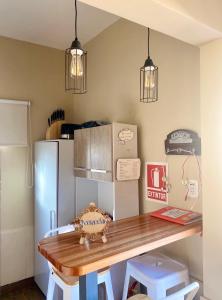 a kitchen with a table and a refrigerator at Casita de Piedra in Trinidad