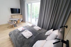 Cama o camas de una habitación en Apartament TERRA - MTN Apartamenty Na Wydmach Pobierowo