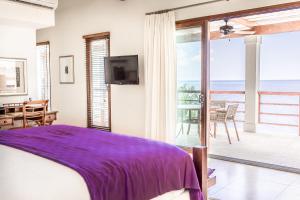 a bedroom with a bed and a view of the ocean at Las Verandas Hotel & Villas in First Bight