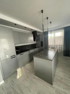 a kitchen with a island in the middle of a room at Solanki Apartament Solankowa Aleja Loft in Inowrocław