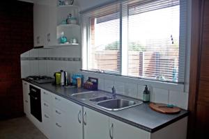 a kitchen counter with a sink and a window at Garland Grove in Ocean Grove