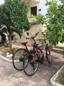 two bikes parked next to each other on a street at La Casa di Emanuella - Rooms & International Suites in Bari