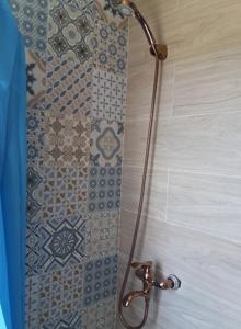a shower in a bathroom with a tiled shower curtain at Villa Thea in Káto Samikón