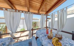 a table with fruit on it on a balcony at S. Lucia in Arzachena