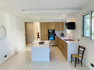 a kitchen with a counter and a table and chairs at GOLFE-JUAN - LUXURY -BEACH APARTMENT in Vallauris