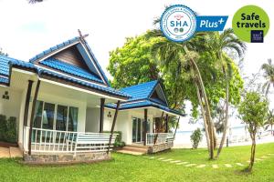 a house with a blue roof and a sign that says safe travels at Assava Dive Resort - SHA Plus in Koh Tao