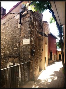 an alley in an old stone building with a sign on it at Le Triplex in Vernet-les-Bains