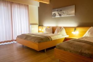 Postel nebo postele na pokoji v ubytování Hotel Auwirt Zentrum