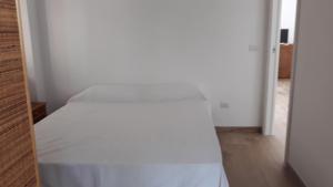 a bedroom with a white bed in a room at marinella in Lamezia Terme