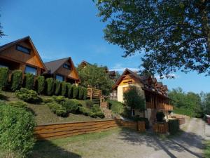 a house with a fence in front of it at Noclegi ''U Wandy'' in Polańczyk