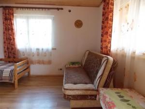 a room with a couch and a bed and a window at Noclegi ''U Wandy'' in Polańczyk