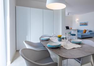 a dining room with a table and chairs at Pareus Beach Resort in Caorle