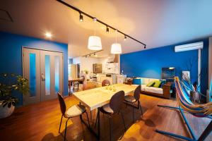 a living room with a table and chairs and a couch at Hostel Coliberty in Tokushima