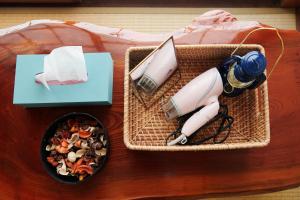 a table with two baskets and a bowl of food at Hostel Coliberty in Tokushima +26 photos