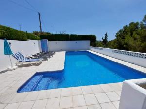 a swimming pool with lounge chairs and a swimming pool at casa DOBRADA in Benissa